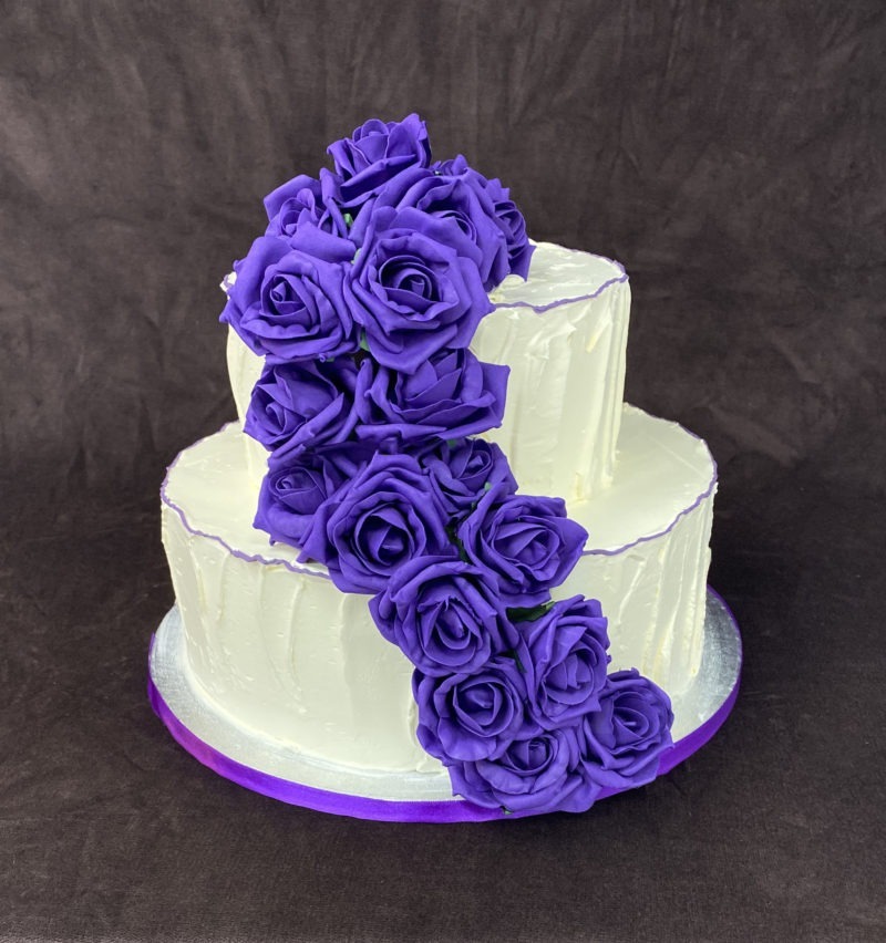wed 5 scaled <div class="woocommerce-product-details__short-description" style="text-align: center;">Two tier wedding cake with ruffled design and purple flowers</div>